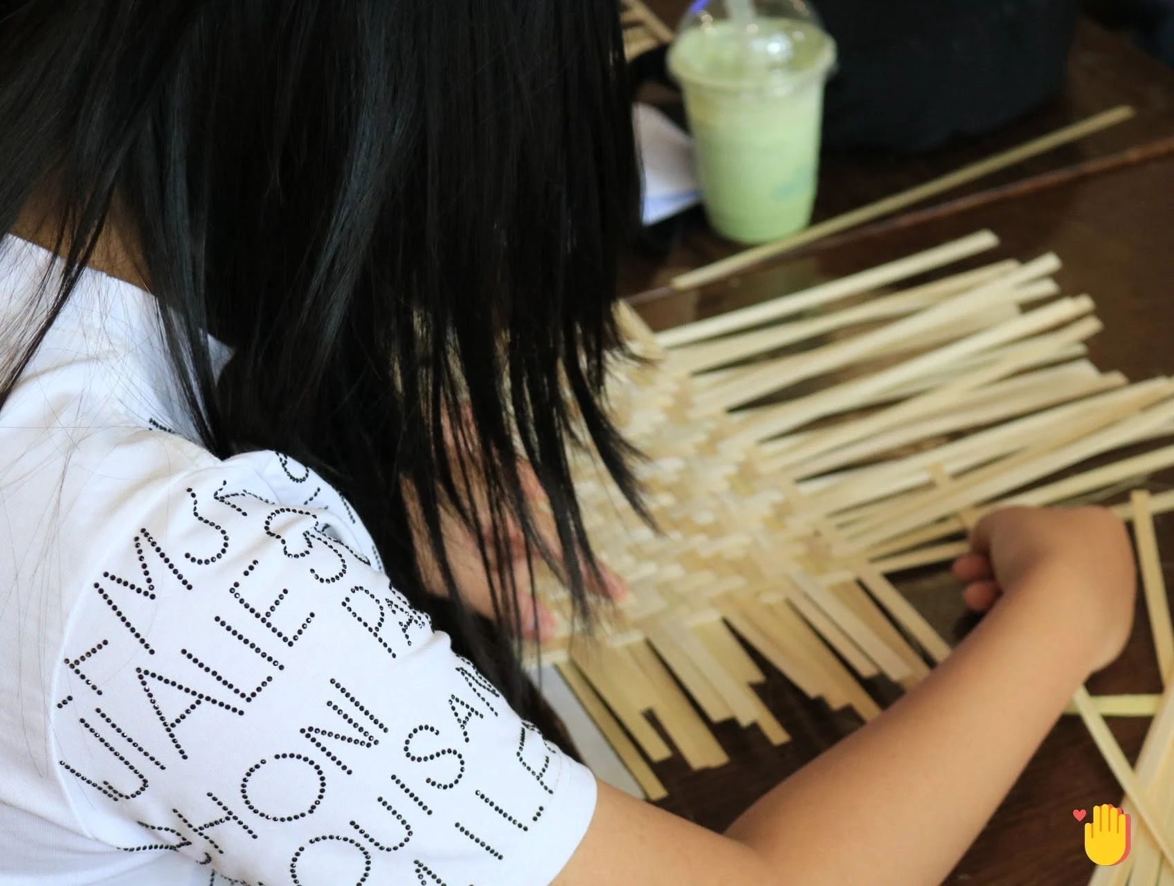 A Handmade Club member weaving bamboo strips