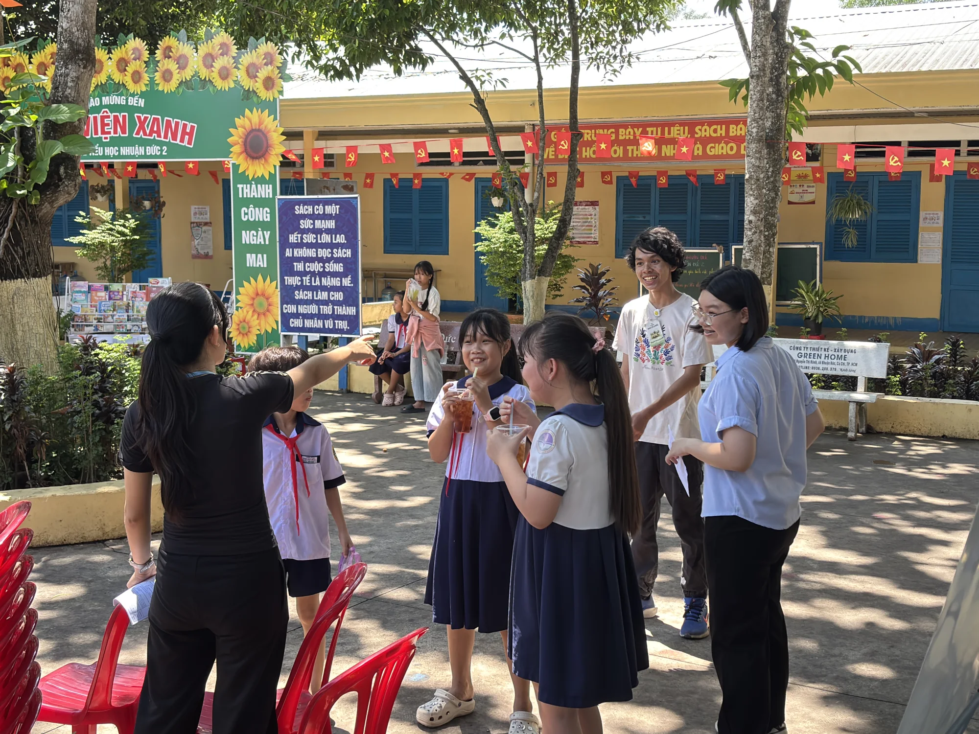 Plant For Change volunteers speaking with students during a school activity