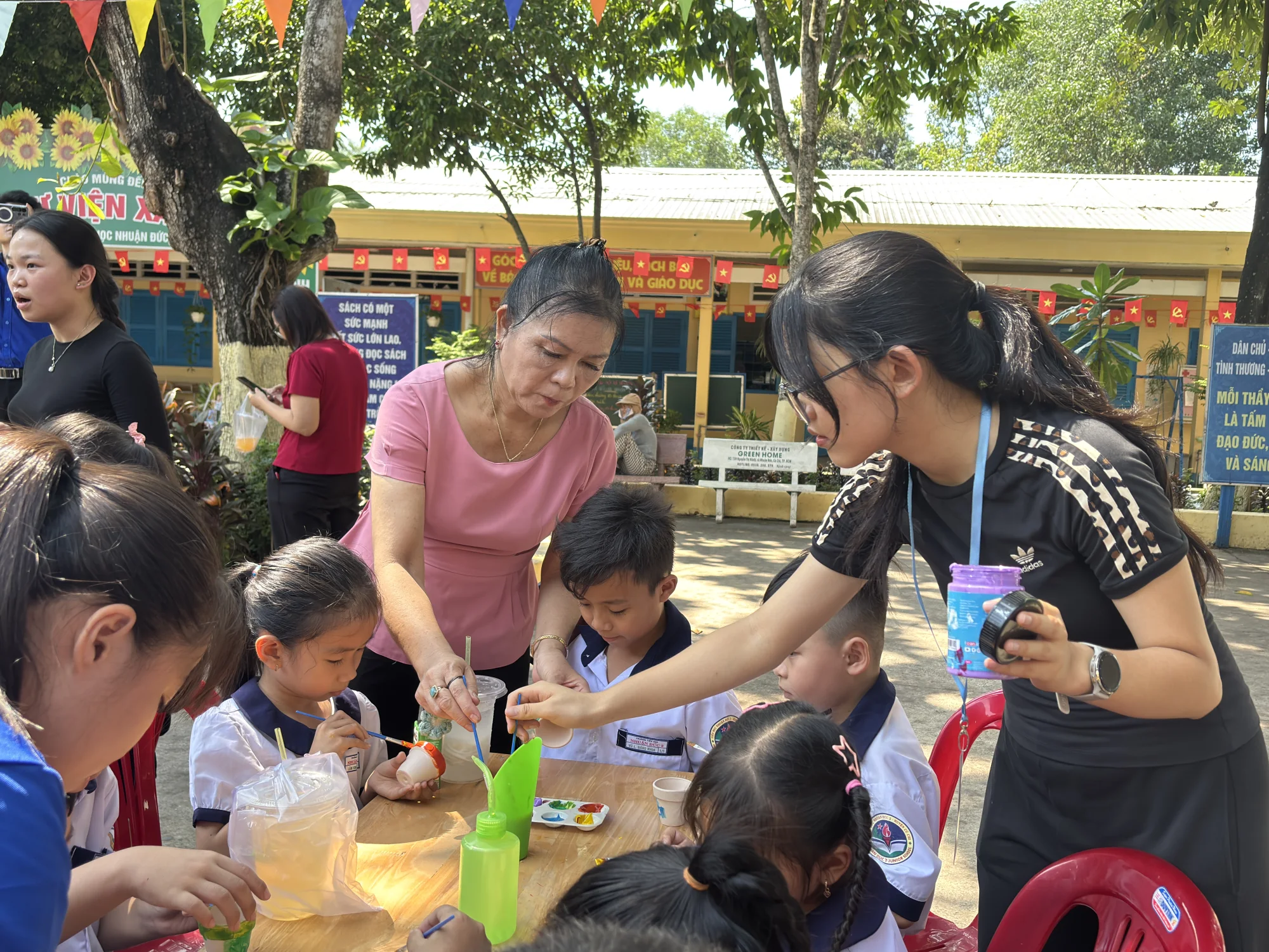 Volunteers guiding children through a creative activity