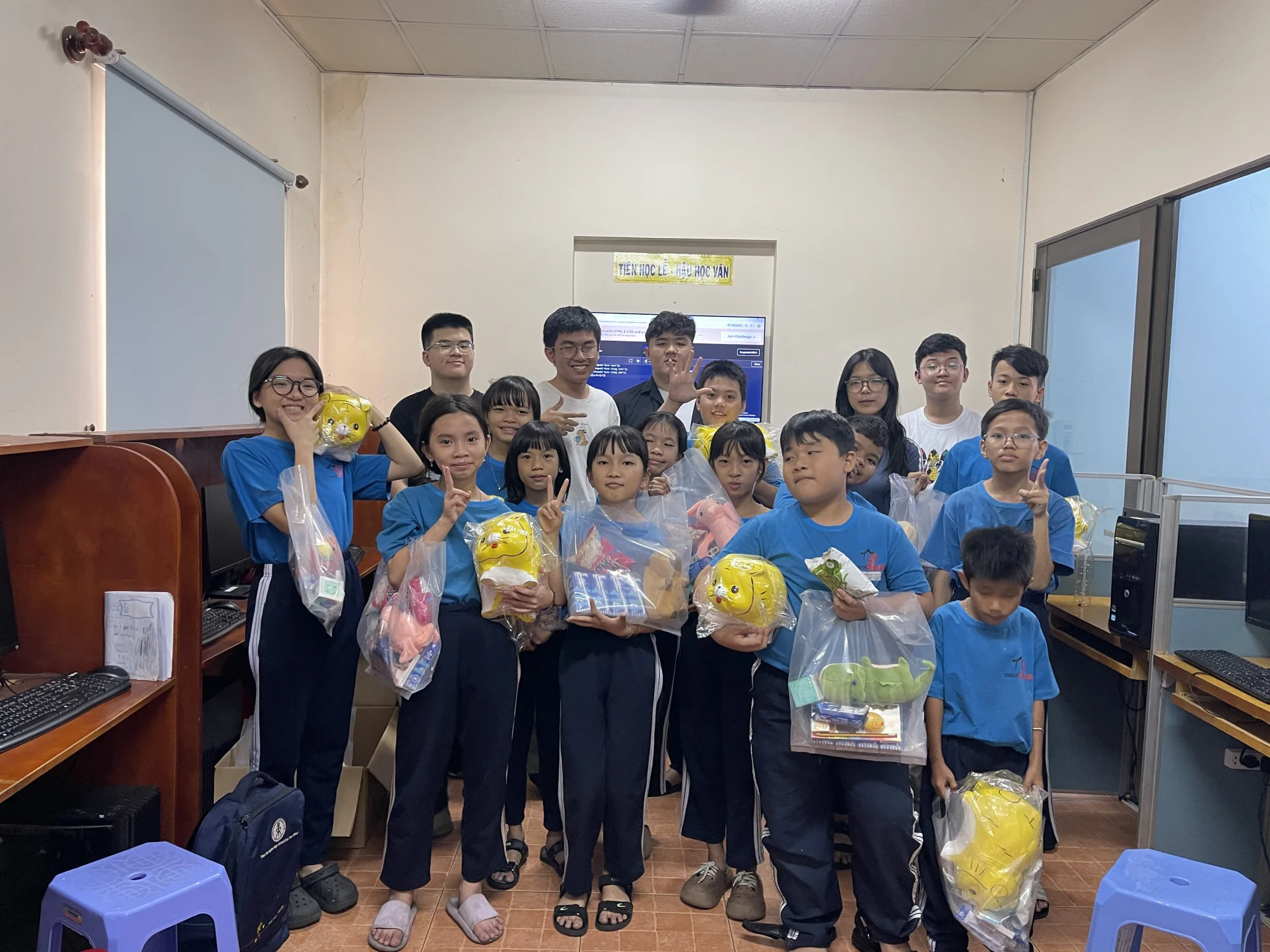 Students and volunteers at Maison Chance holding donated gift packages